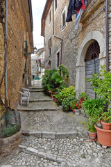Fototapeta na wymiar A small street among the old houses of Arce, a medieval village in the Lazio region in Italy.