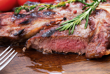 sliced gilled beef steak on wooden background