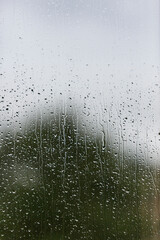 Rain Drops on a Window with a Building in the Background with Copy Space