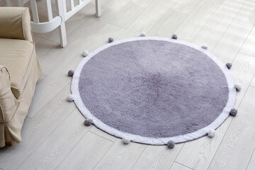 Stylish soft rug on floor in room