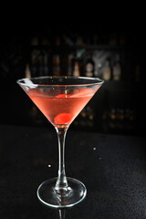 bartender special cold red alcohol bloody mary cocktail with cherry juice in tall glass goblet on black background luxury hotel pub iced beverage menu