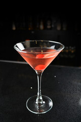 bartender special cold red alcohol bloody mary cocktail with cherry juice in tall glass goblet on black background luxury hotel pub iced beverage menu