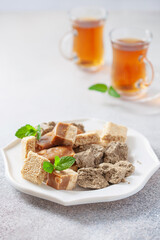 Oriental sweetness.  Nougat, halva and  tea on a table.