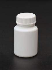 Blank white plastic bottle with a screw top lid. Typical pill bottle on a black background. Packaging mock up