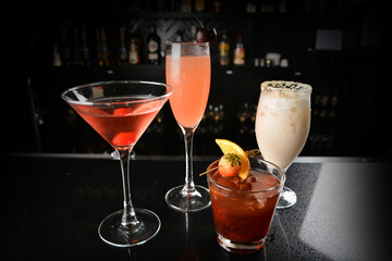 bartender make special cold cocktail or mocktail in tall glass goblet on black background luxury...