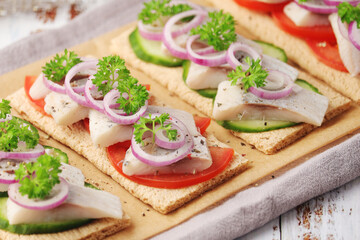Sandwiches with herring and vegetables