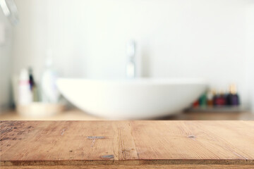 empty table board and defocused indoor bathroom background. product display concept