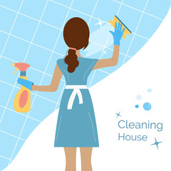 Woman in a blue uniform is washing the tile with a sponge, holding a spray in her hands