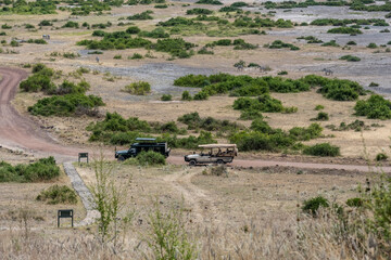 SUVs for savannah safari at the foot of the hill in Africa 