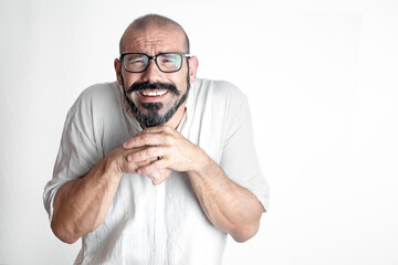 Caucasian man with mustache and glasses with vision problems, with hands on chest, dressed in white on white background isolated