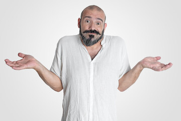 Caucasian man with mustache and beard making an expression of I don't know, dressed in white on white background