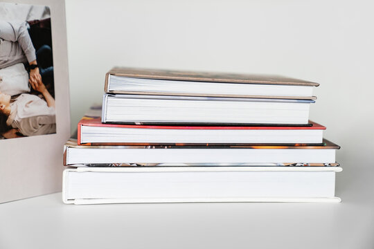 photobooks folded on top of each other on a white table. printing products.