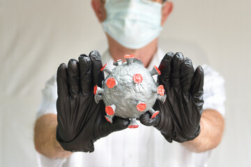 The hands of a man in gloves repel the virus
