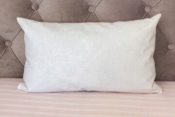 White lumbar pillow on a couch, case Mockup.