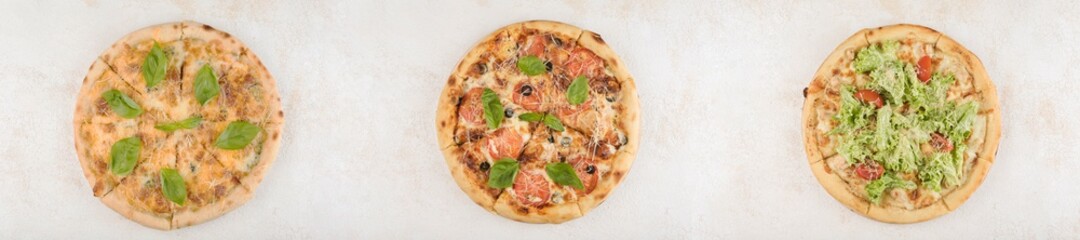 Collage of three pizzas with different fillings and fresh lettuce with olives on a light background, top view with a copy space for the text. A long panorama of photos.