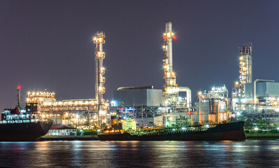 Fototapeta na wymiar The landscape view oil and gas tank with oil refinery background at night with soft blurred focus. Intend to use for industry and industrial background element.