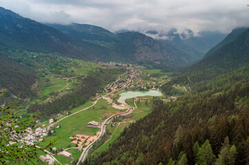 Fototapeta na wymiar Aerial view of the little mountain town of Brusson with its nice lake in Ayas valley in Val D'Aosta, Italy