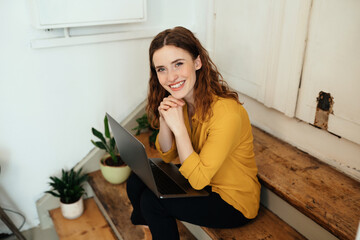 Cute charismatic young woman smiling up at the camera