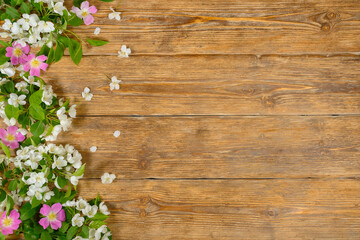 White and pink spring flowers on old wooden table, floral background