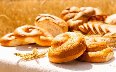 lot of different flavored bread, wheat, rye, on the table in the field outside