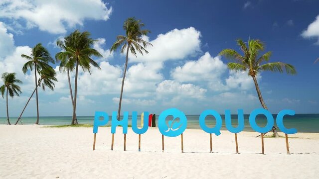 The tropical seascape on a sunny afternoon with slanting coconut trees and clean, white sand great when coming to the beautiful pearl island of Phu Quoc, Vietnam.