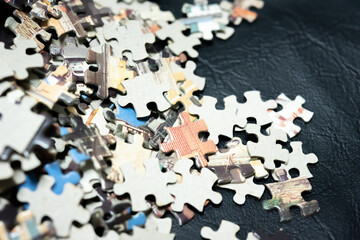 jigsaw puzzle on wooden background. to represent how complexity in game and challenge. plan and goal as concept.