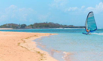 Beautiful cloudy sky with Windsurfer Surfing The Wind On Waves - Panoramic seaview with picturesque...