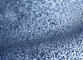 Many different drops of water on the metal surface