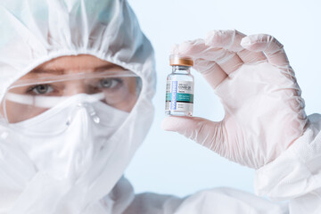 NO LOGOS OR TRADEMARKS!  SELF MADE LABELS! Close up view of doctor with an ampule of covid vaccine...