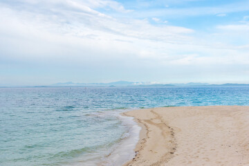 Obraz premium Nature in twilight period which including of sunrise over the sea and the nice beach. Summer beach with blue water and purple sky at the sunset. 