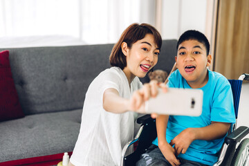 Portrait of asian physiotherapist carer helping and playing with special disabled child health problem by doing exercises sitting in wheelchair in rehabilitation clinic.disability care concept