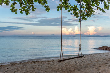 Nature in twilight period which including of sunrise over the sea and the nice beach. Summer beach with blue water and purple sky at the sunset.	
