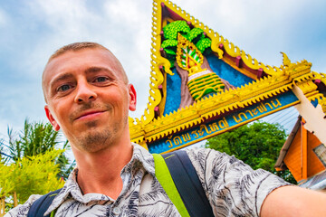 Tourist backpacker at welcome entrance gate on Koh Samui Thailand.