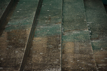 Wet outdoor staircase with raindrops falling
