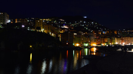 incredible view of the small port of Camogli in the evening, lights, colors and reflections on the sea create a magical atmosphere