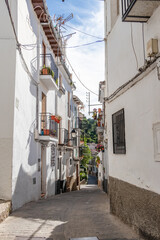 Fototapeta na wymiar Typical narrow street in the town of Cazorla, in Jaen, Andalucia, Spain. White villages of Andalucia