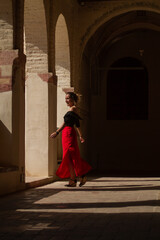 Fototapeta na wymiar young woman walking inside an ancient building in Spain
