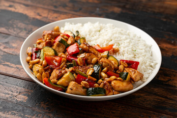 Fototapeta premium Kung Pao Chicken with Peppers, zucchini and rice. Asian take away food