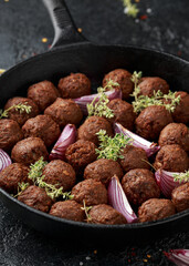 Vegetarian vegan meatballs with thyme and onion in cast iron skillet frying pan