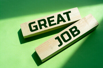 Great job. Wooden blocks with words 'great job' on beautiful green background. Business and great job concept, copy space. © Uuganbayar