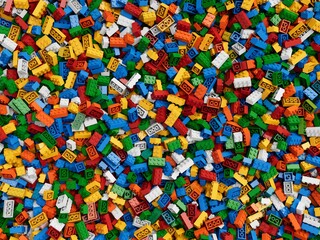 Pile of colorful plastic blocks background for placing content over - 3D rendering