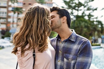 Fototapeta premium Young hispanic couple hugging in love at the city. Girlfriend and boyfriend together in love walking on the street