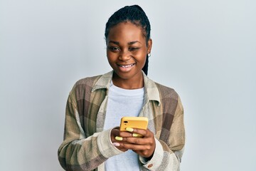 Young african american woman using smartphone winking looking at the camera with sexy expression,...