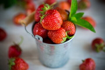 red ripe natural strawberries on a wooden table
