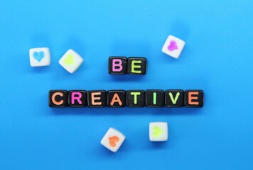 small black cubes with the words Be creative colored