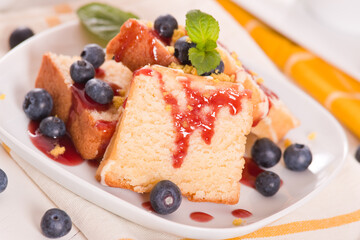 Lemon pund cake with blueberries and strawberry syrup.