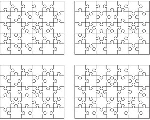 Separate pieces of four white jigsaw puzzles