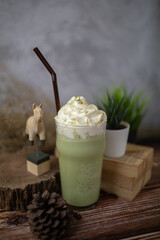 Fresh milk green tea menu is placed on a wooden table. The background is a polished wall. beautifully arranged Suitable for making menus - 443234334
