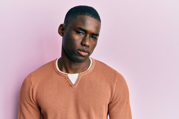 Young african american man wearing casual clothes skeptic and nervous, frowning upset because of problem. negative person.