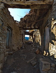 Fototapeta na wymiar Russia. North-Eastern Caucasus, Dagestan. The stone houses of the abandoned part of the mountain village of Khushtada destroyed by time. Traditionally, all houses and fences are made of rock.